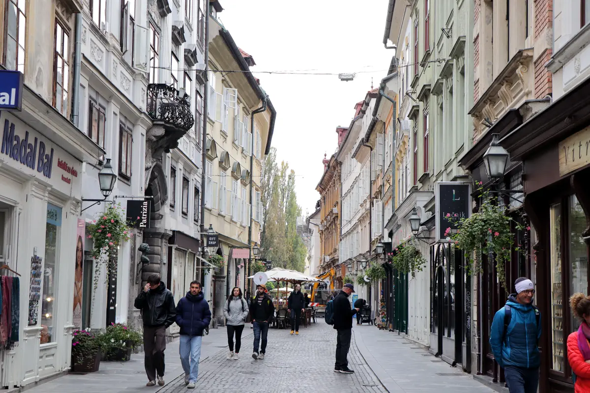 Pedestrian shopping street lined with old townhouses in a European city